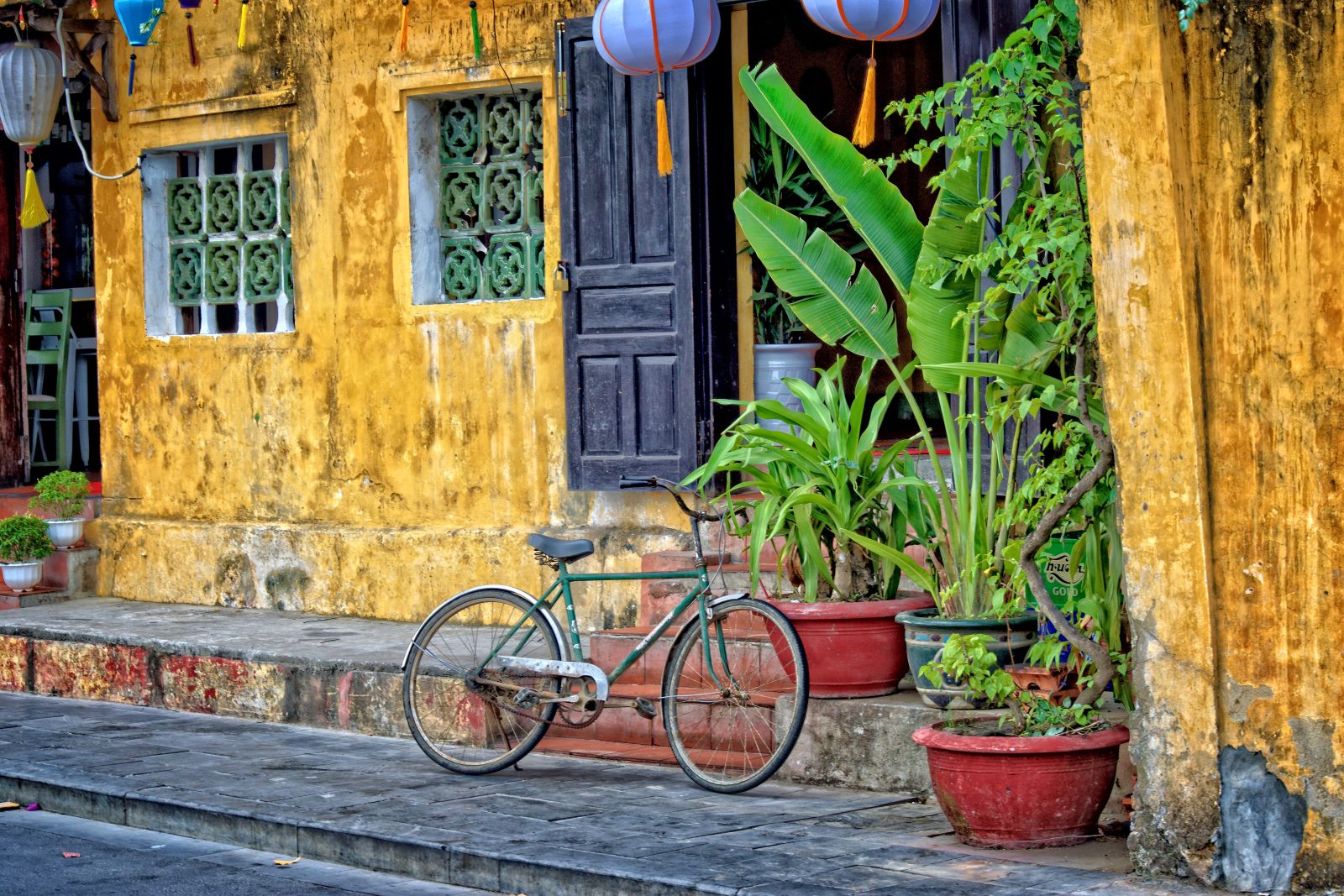 Bicycle set against a yellow house on a typical street in Hoi An, Vietnam