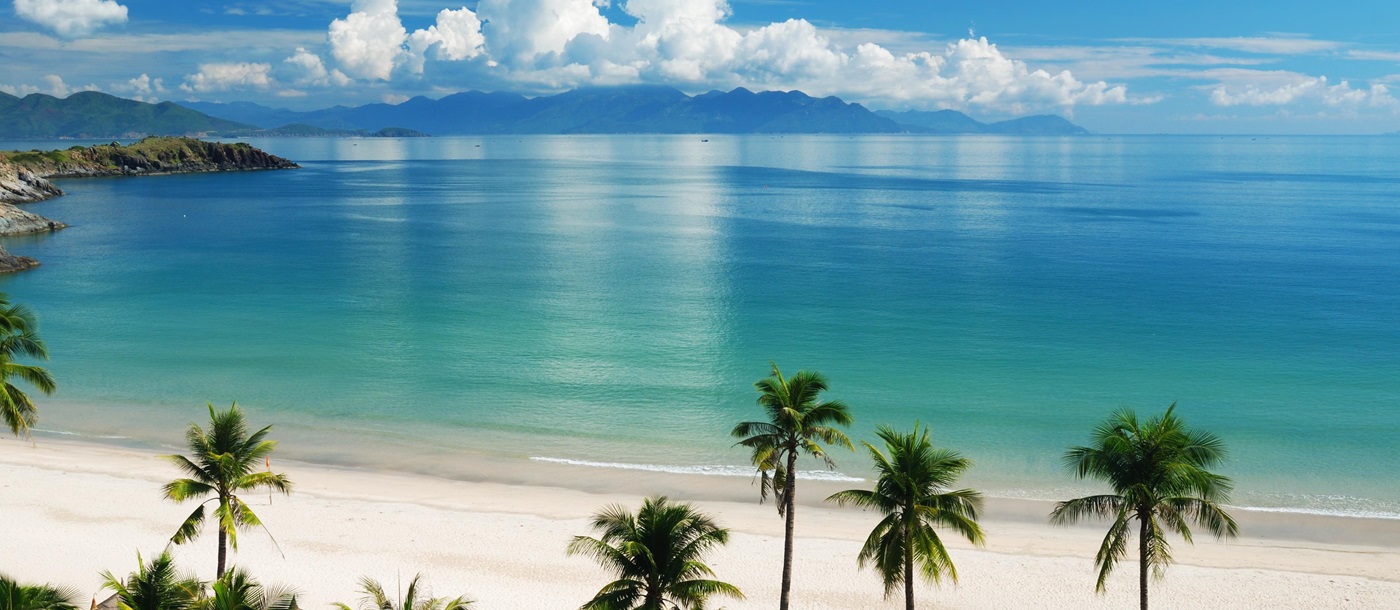 Palm trees and golden sand Nha Trang beach in Vietnam