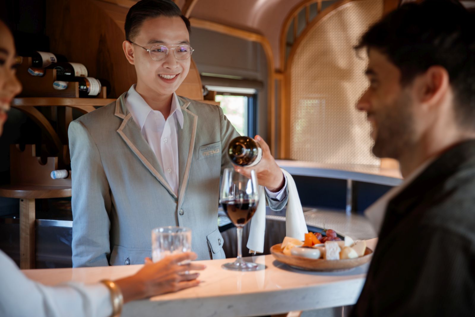 Passengers enjoying drinks at the bar on Anantara's Vietage luxury train in Vietnam