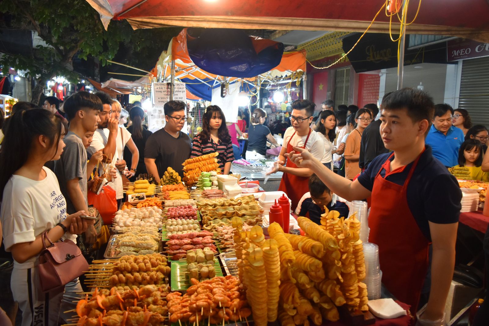 Locals gathered around a food vendor at a night market in Vietnam