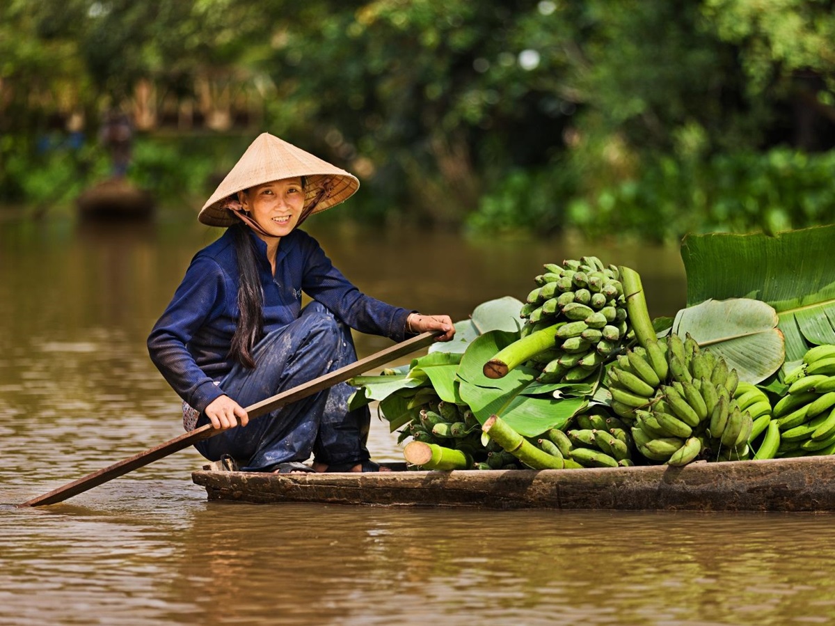 A lady on a boat on the Mekong River