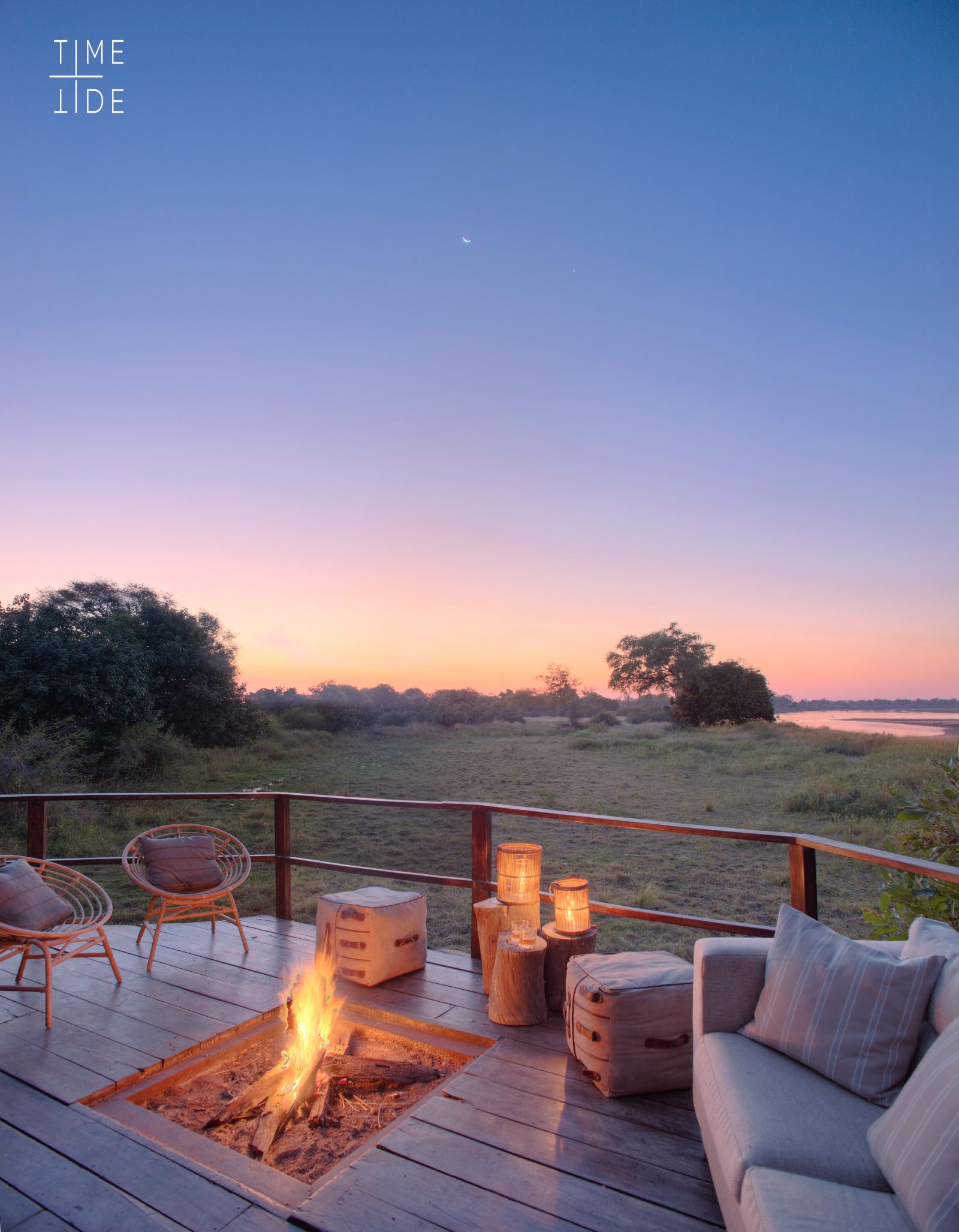 Comfortable campfire deck with couch and chairs overlooking the river at luxury safari camp Kakuli Bush Camp in Zambia's South Luangwa National Park