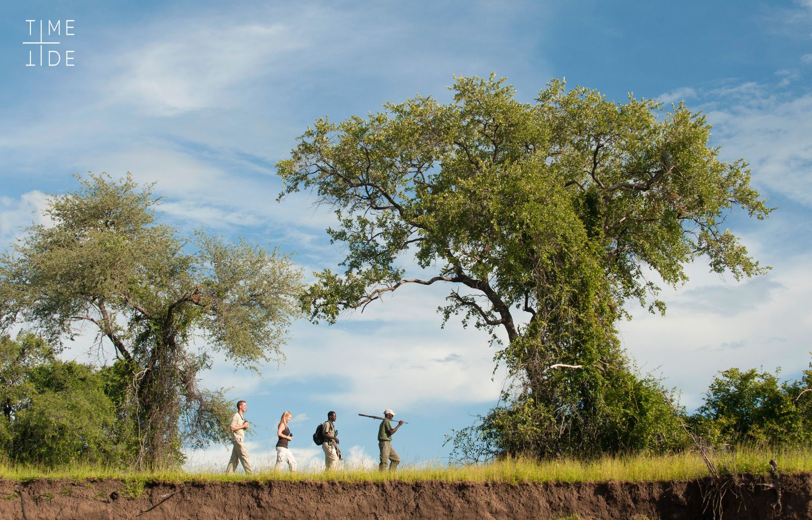 Guests and guide on a walking safari at luxury safari camp Kakuli Bush Camp in Zambia's South Luangwa National Park