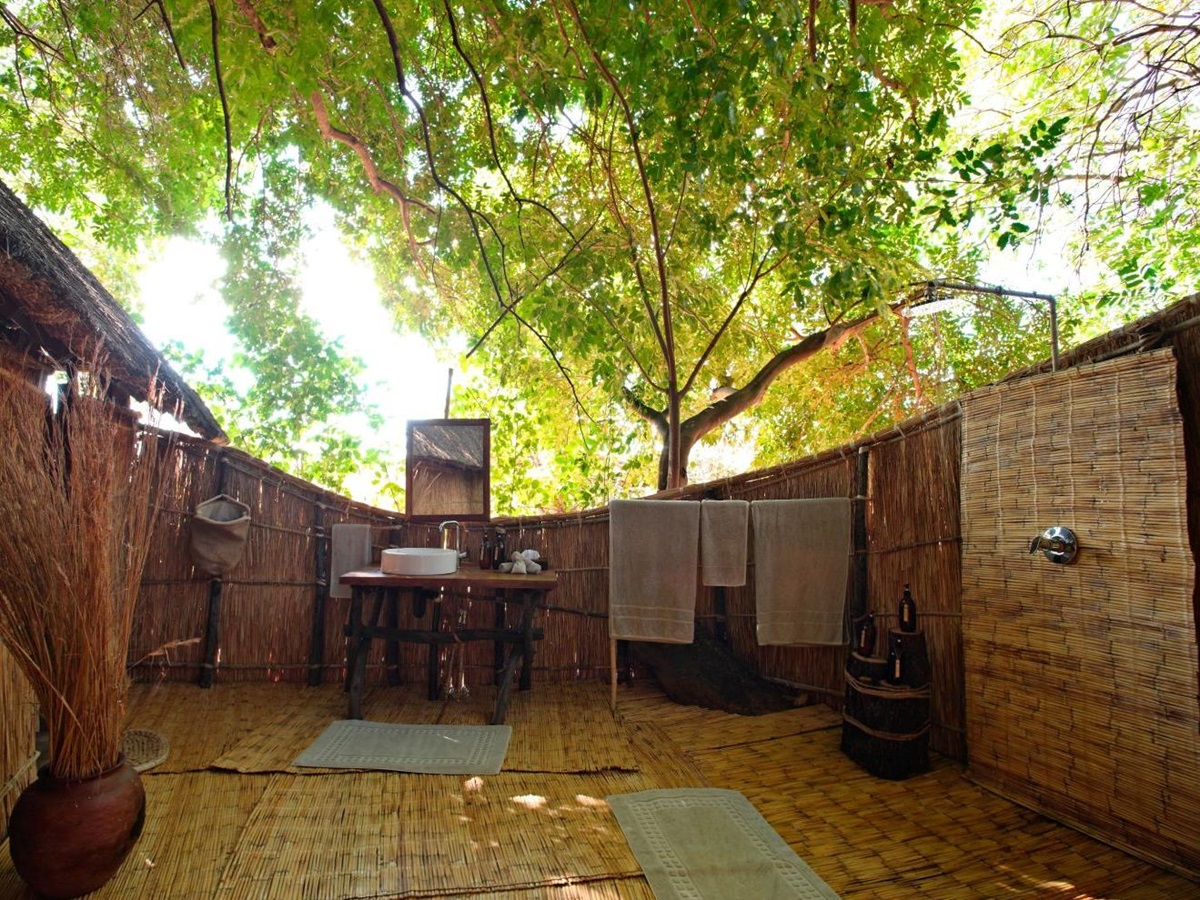 Open Air en-suite bathroom of a tented suite at luxury safari camp Luwi Bush Camp in Zambia