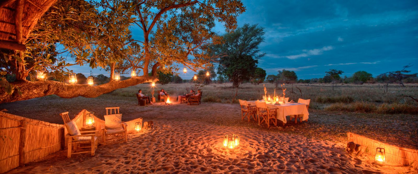 Lantern-lit dinner in a dry riverbed at luxury safari camp Luwi Bush Camp in Zambia