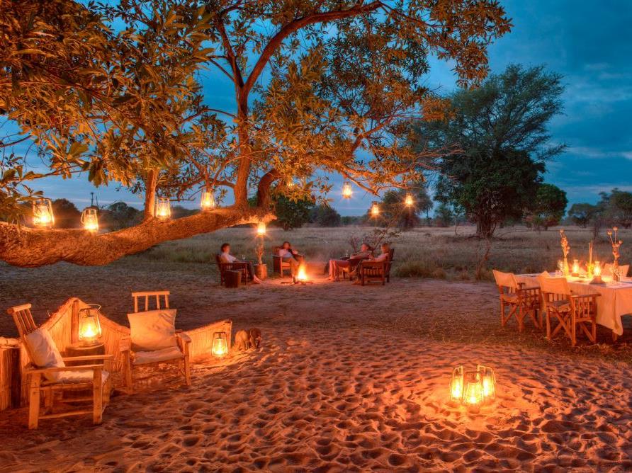 Lantern-lit dinner in a dry riverbed at luxury safari camp Luwi Bush Camp in Zambia