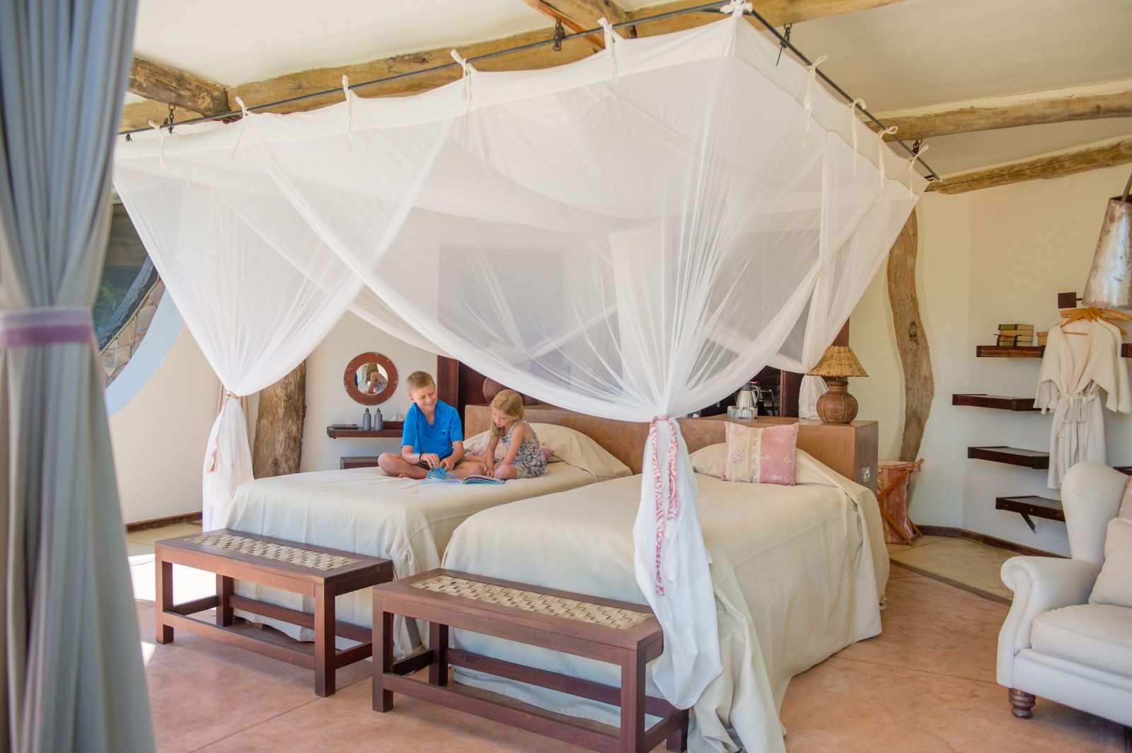 Children relaxing on one of the bedrooms of the Luangwa Safari House in Zambia