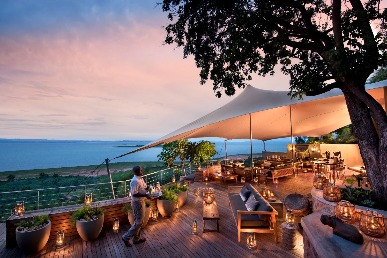 Sunset view of the main deck at luxury safari lodge Bumi Hills in Zimbabwe