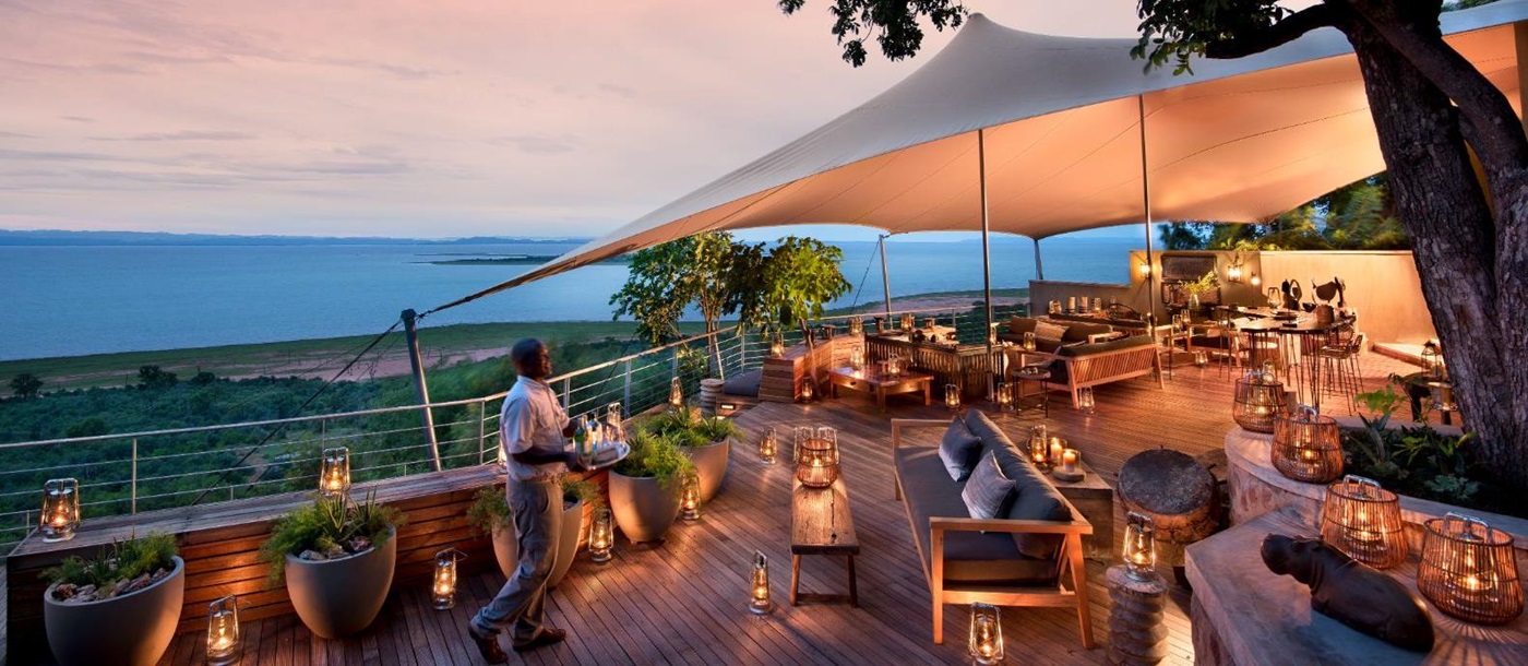 Sunset view of the main deck at luxury safari lodge Bumi Hills in Zimbabwe