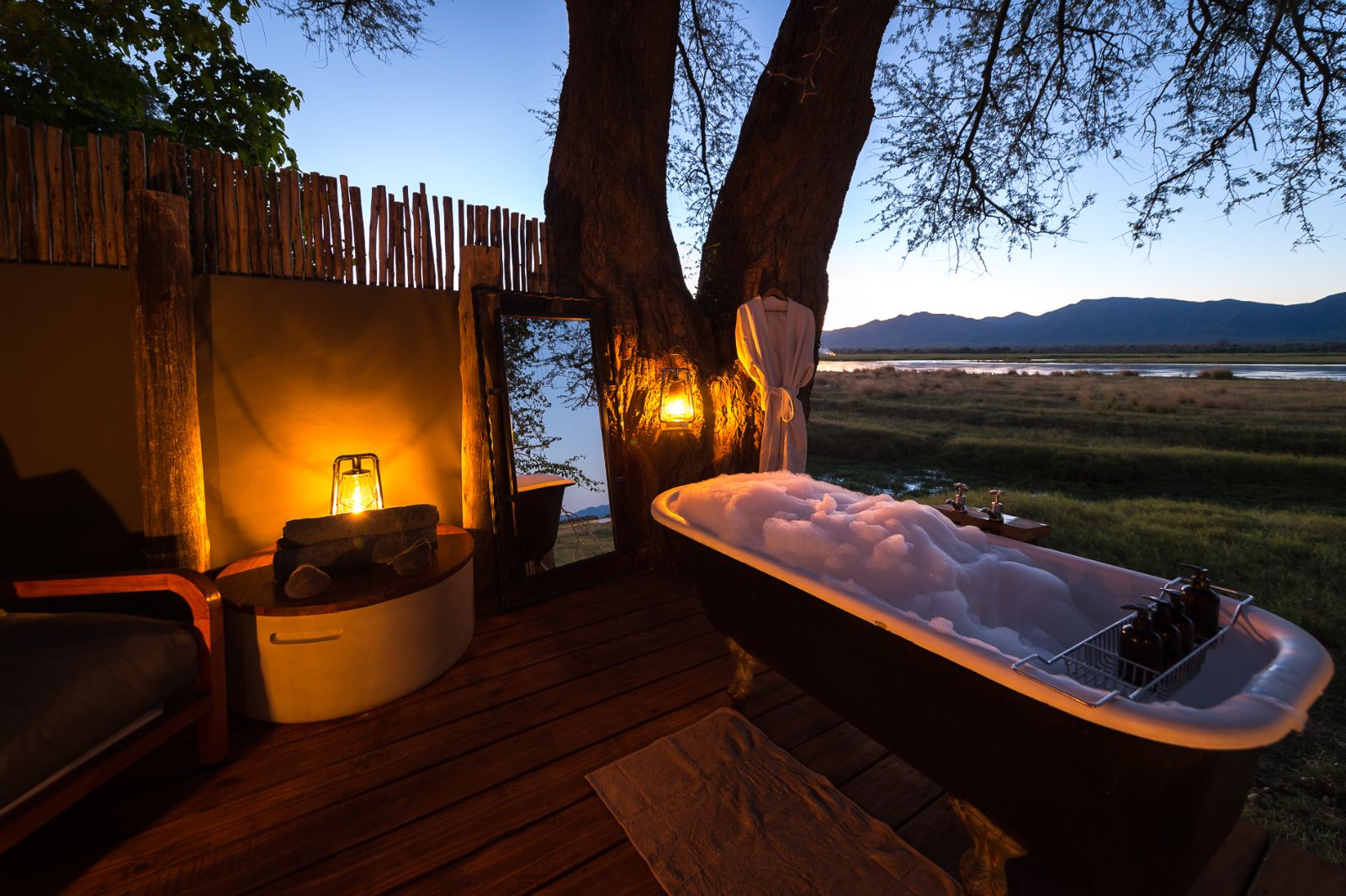 Outdoor bath on decking at luxury camp Ruckomechi