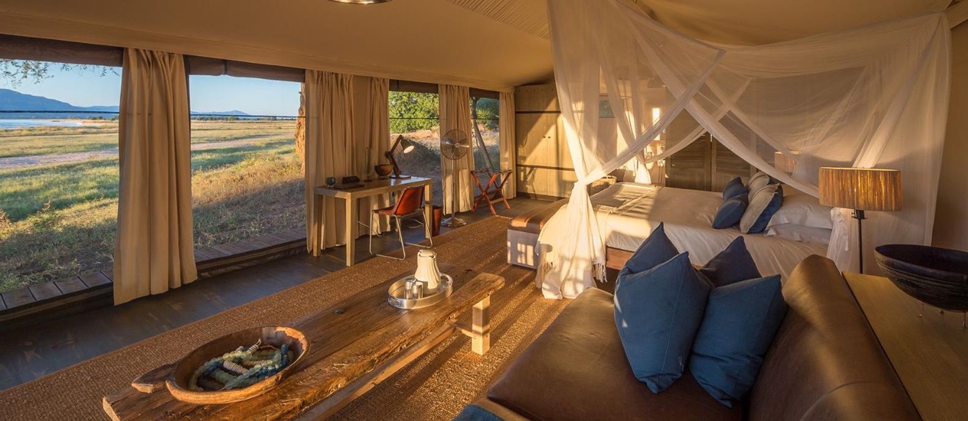 Interior of tented room with view at luxury camp Ruckomechi