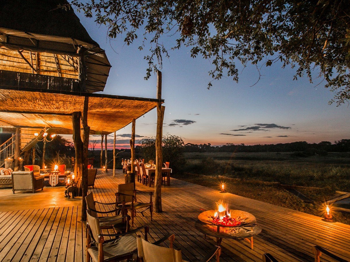 Terrace illuminated by night at The Hide safari lodge Zimbabwe