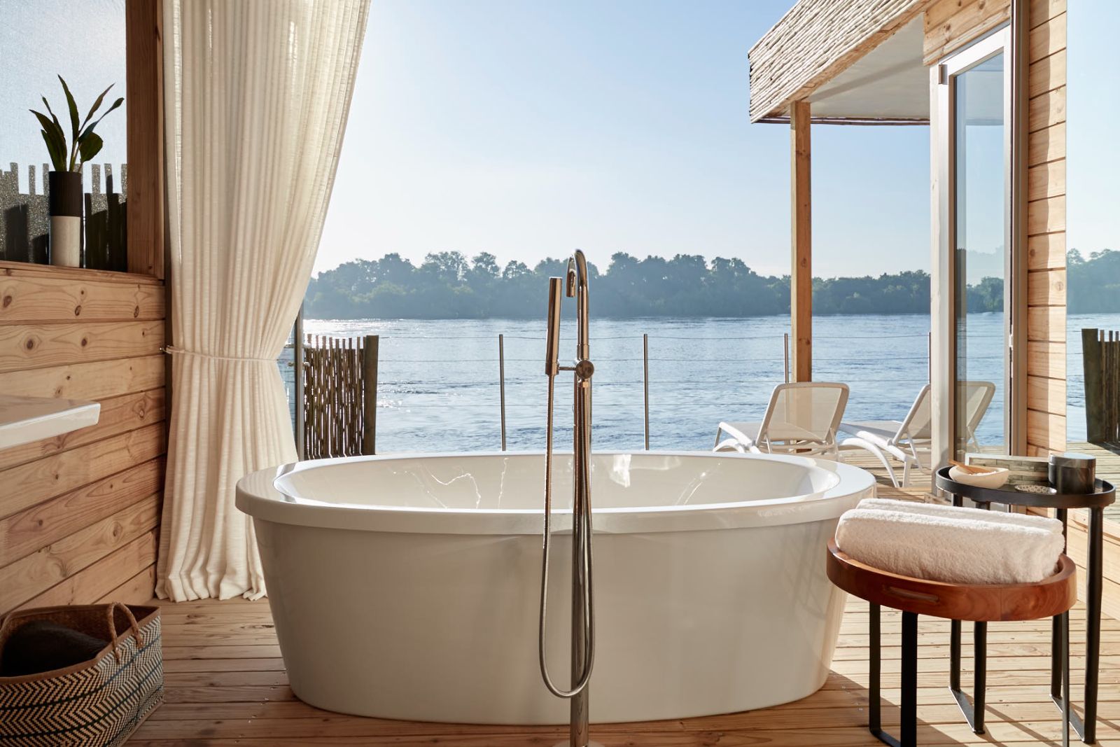 Bathroom with freestanding tub at Victoria Falls River Lodge in Zambezi National Park in Zimbabwe