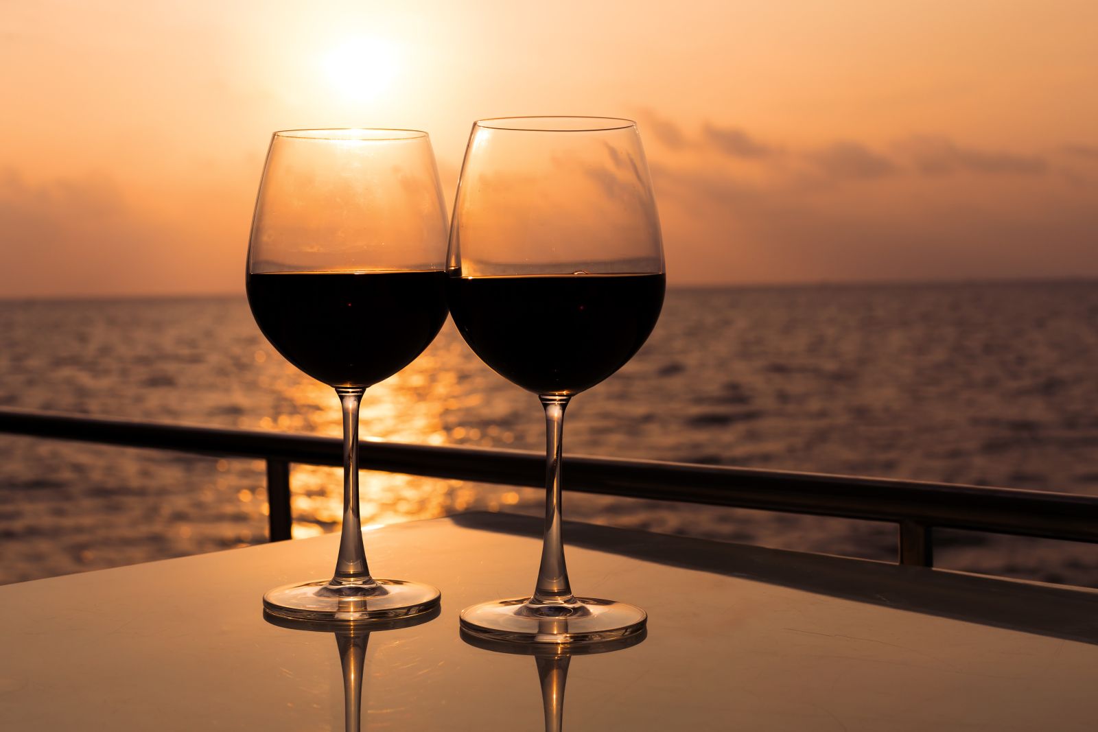 Glasses of wine being enjoyed at sunset on the deck of a gulet