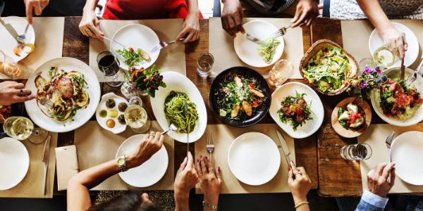 Overhead view of a group of guests sat around a dining table