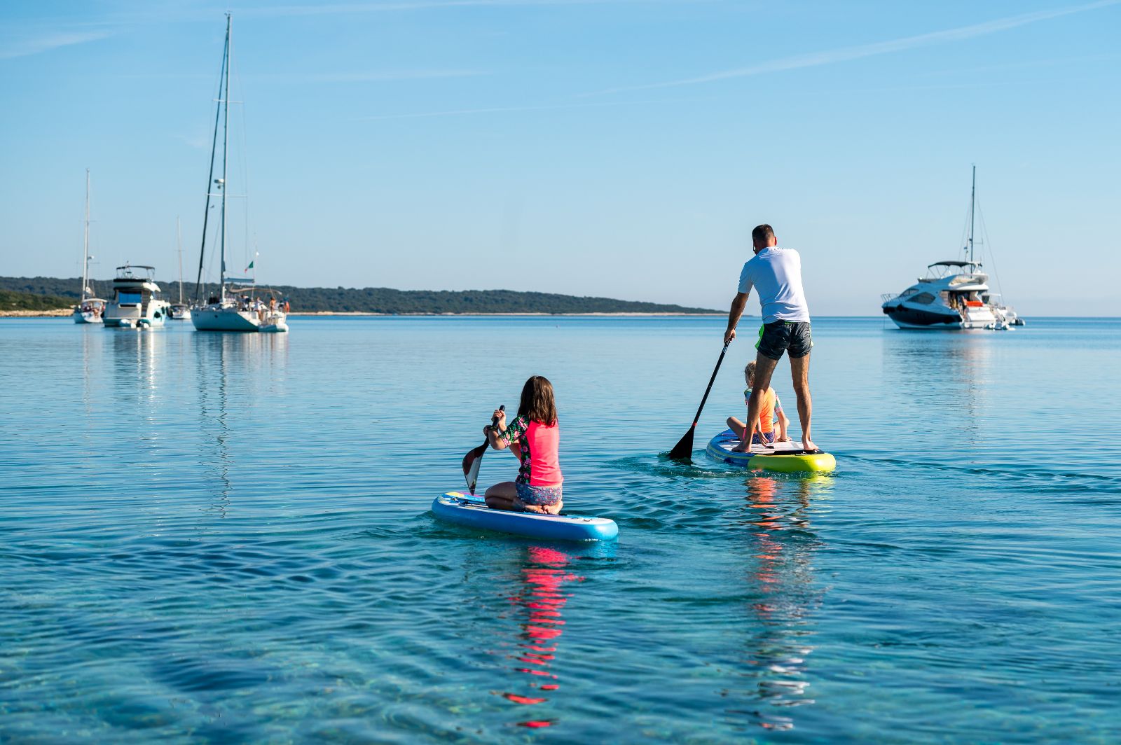 A family paddleboarding on the ocean