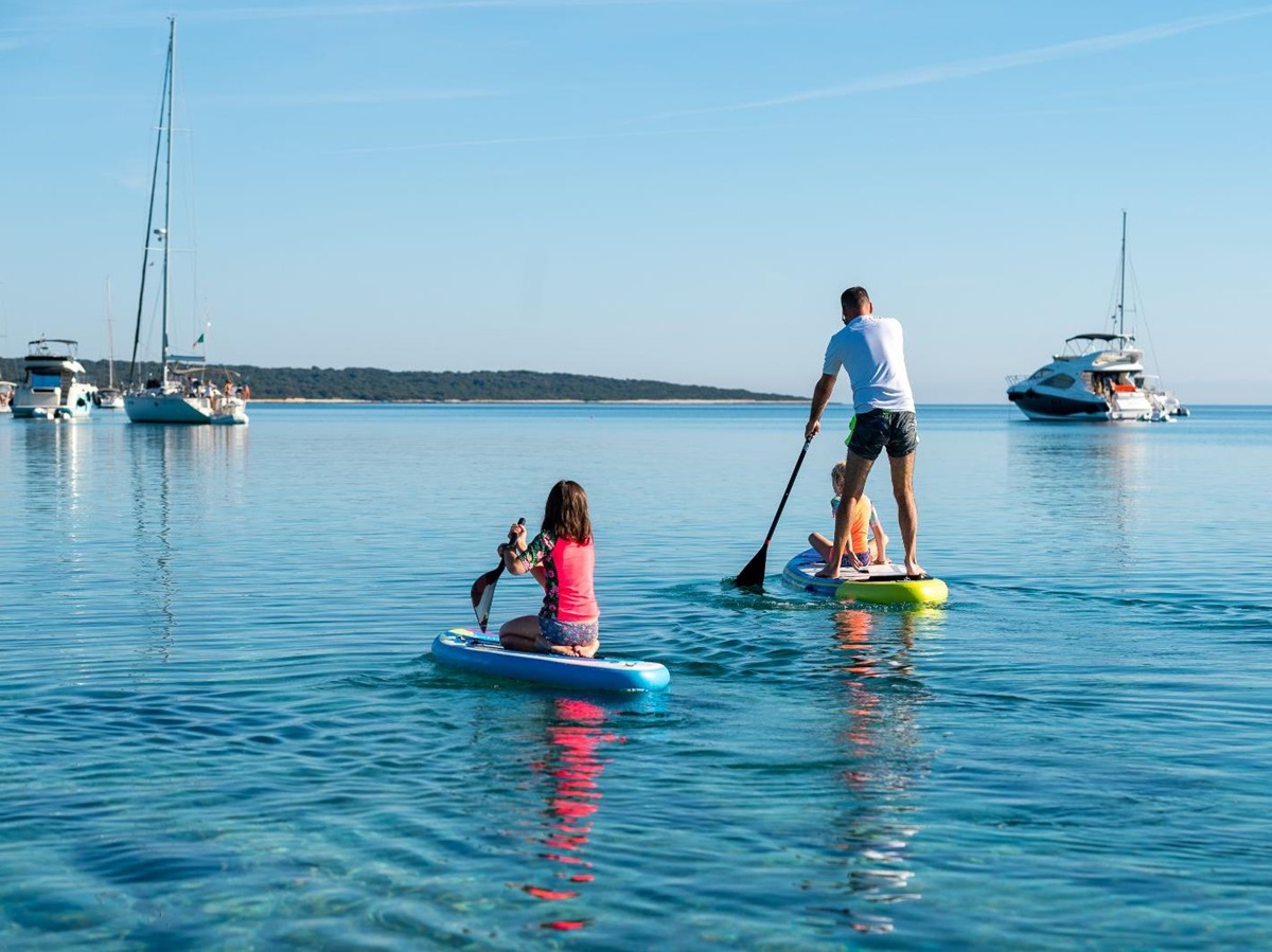 A family paddleboarding on the ocean