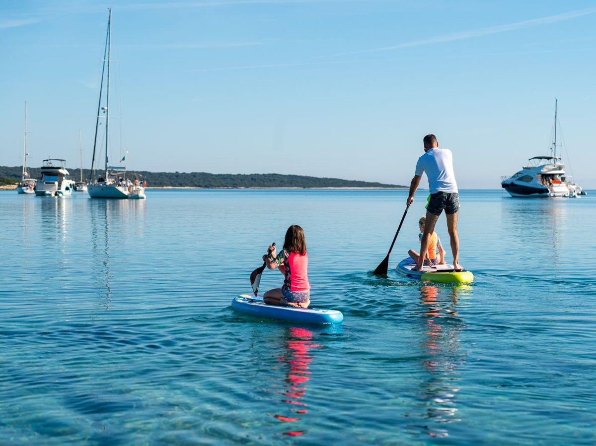 A family paddleboarding on the ocean