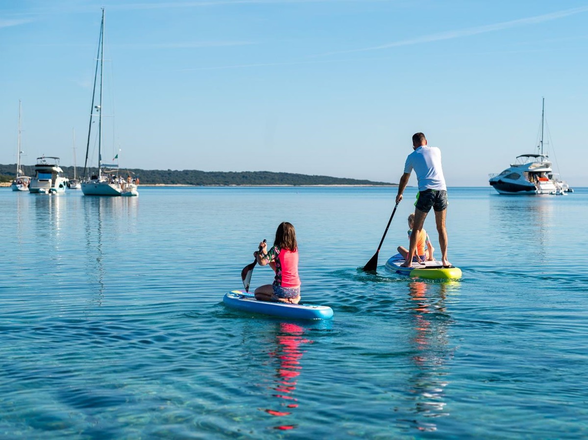 A family paddleboarding on the ocean