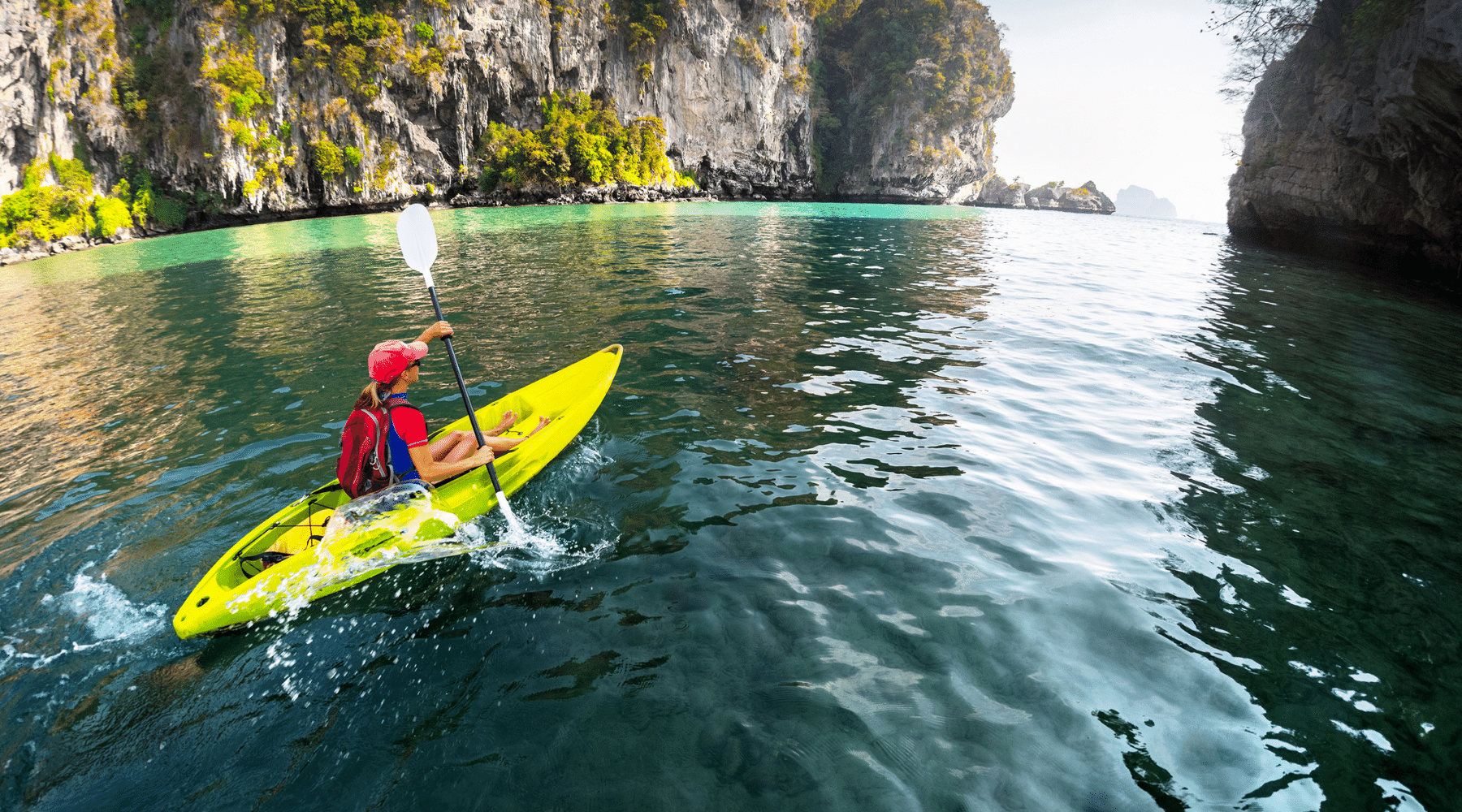 Lady kayaking in a tropical bay