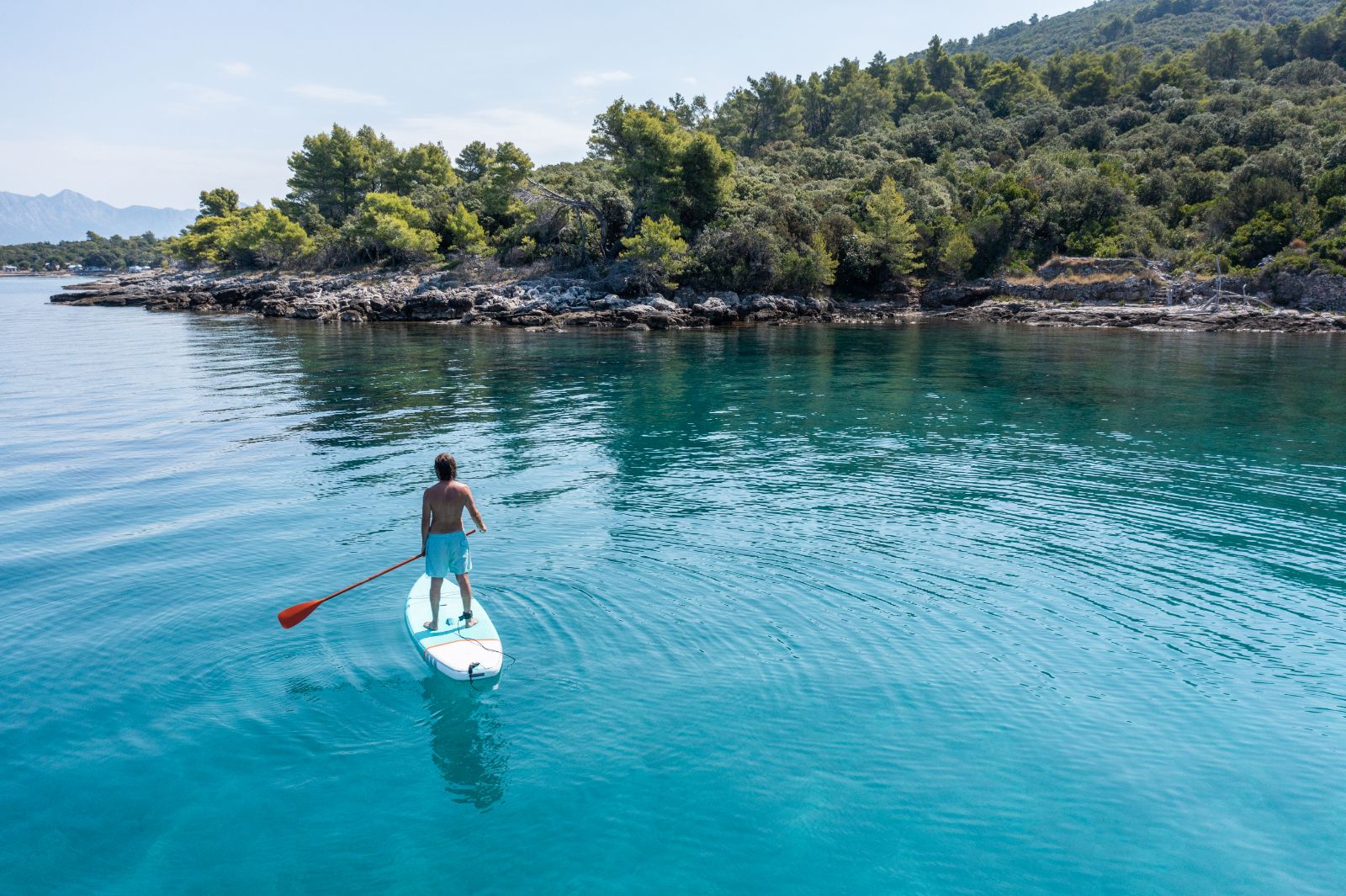 A man paddleboarding on the ocean
