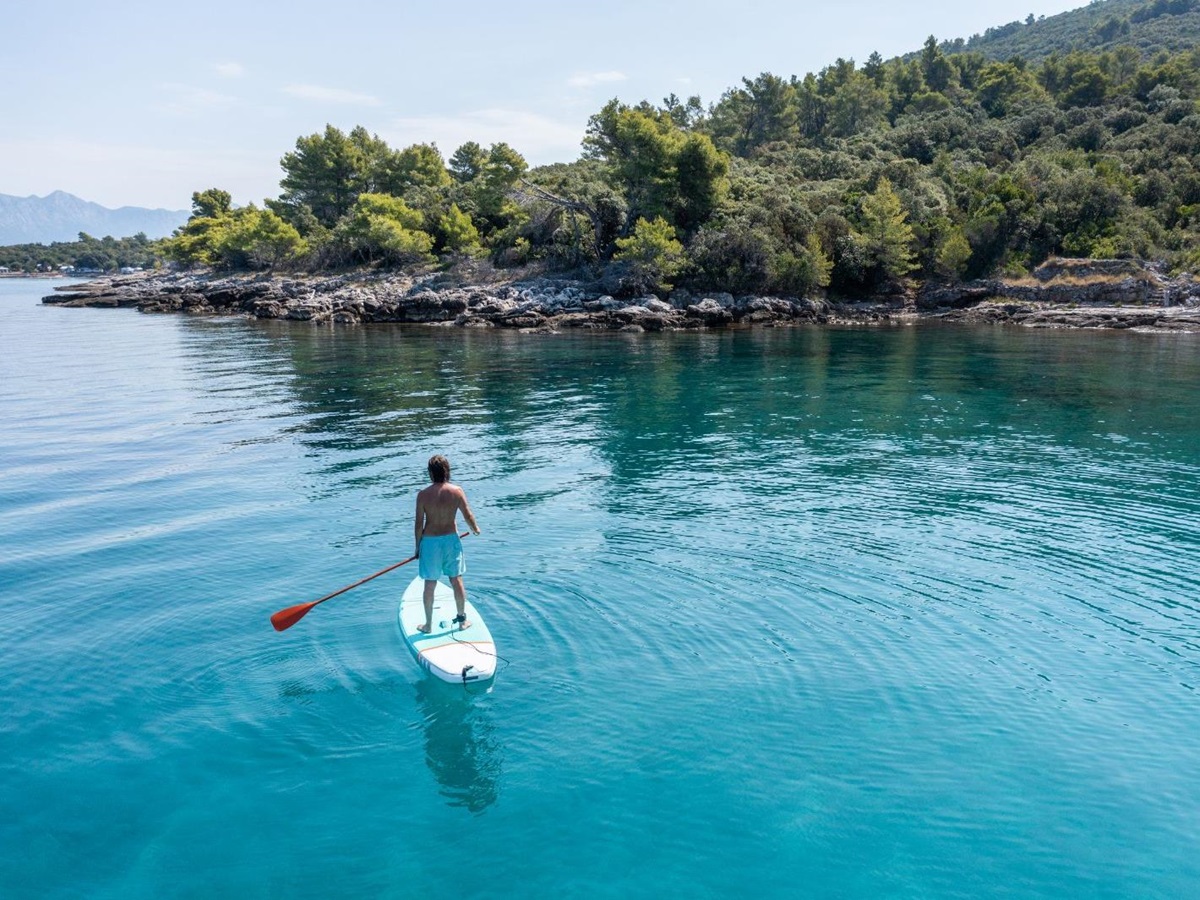 A man paddleboarding on the ocean