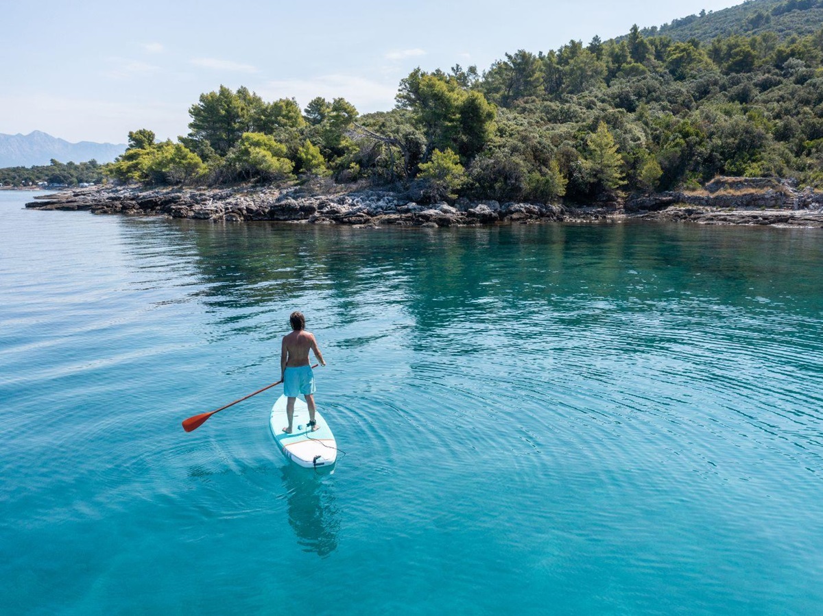 A man paddleboarding on the ocean