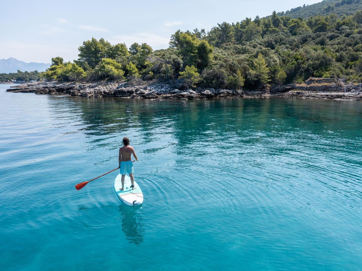 A man paddleboarding on the ocean