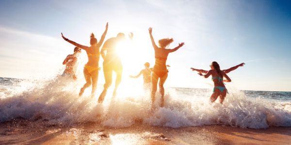 A group of people running into the sea