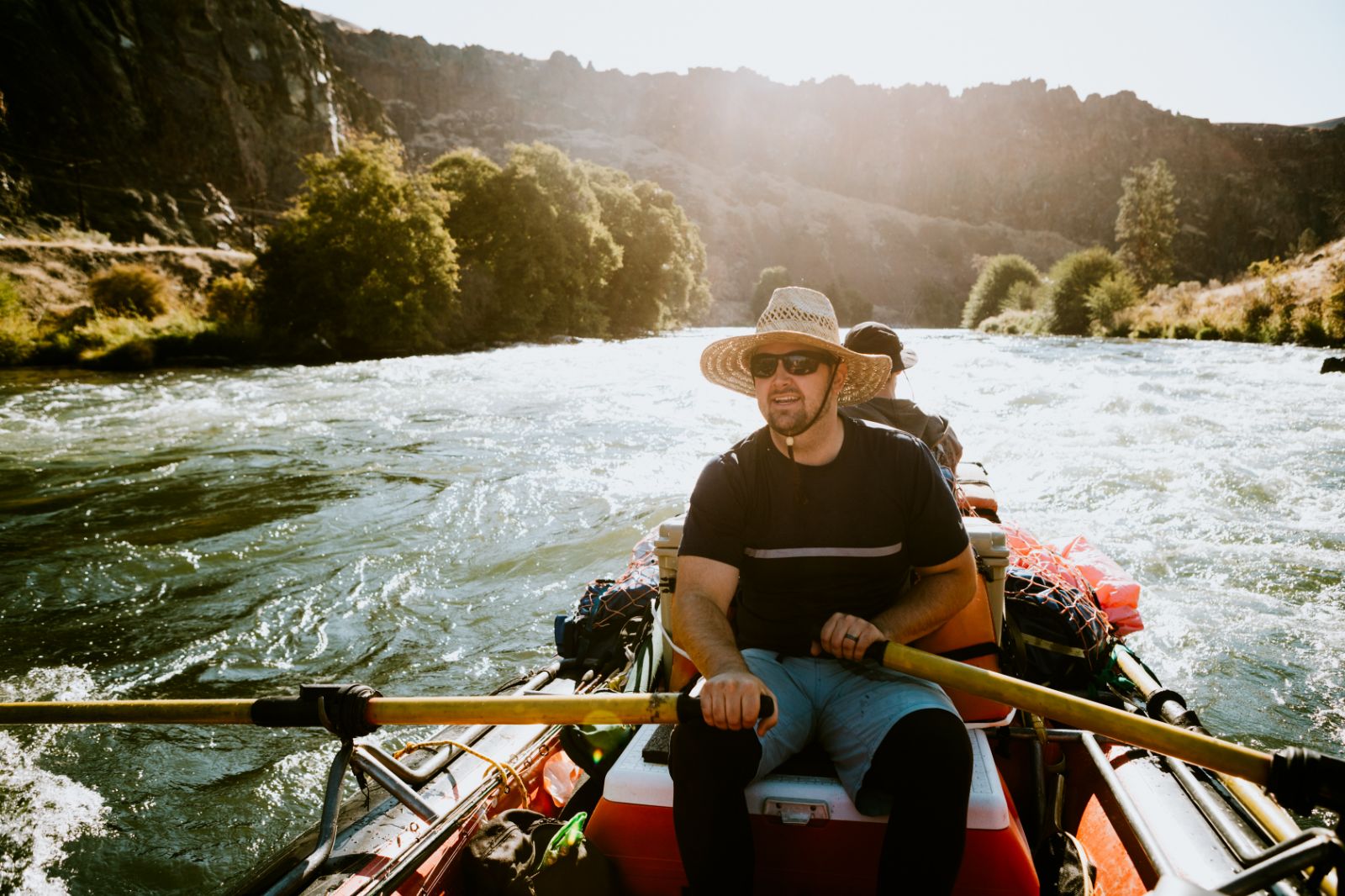 Man kayaking on a river in the sunshine in Oregon USA