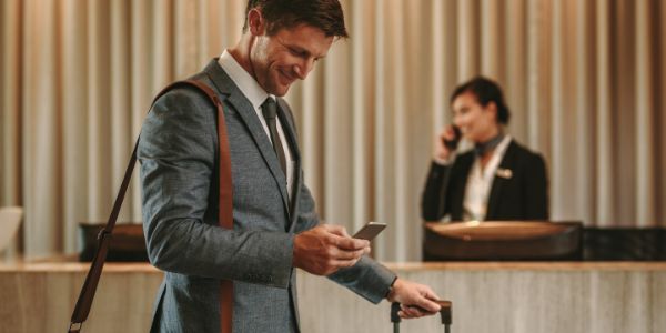 A man in his hotel checking the travel app