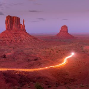 Lights illuminating Monument Valley at dusk