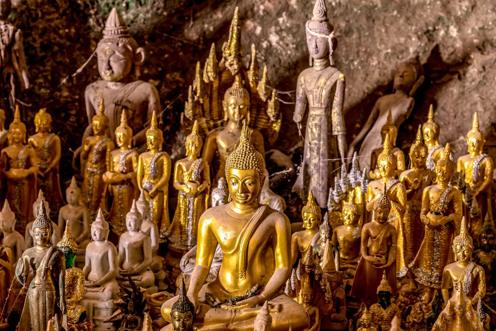 Golden Buddha statues in Pak Ou caves in Laos