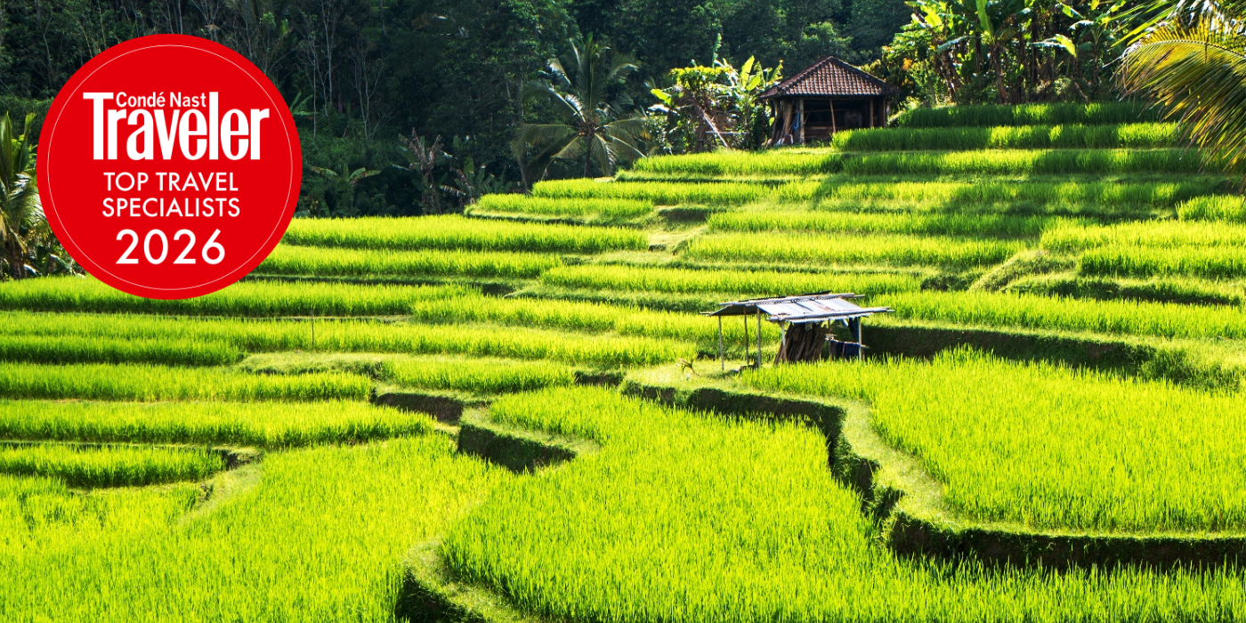Rice paddies background with Conde Nast Traveler Top Travel Specialist award logo for 2026