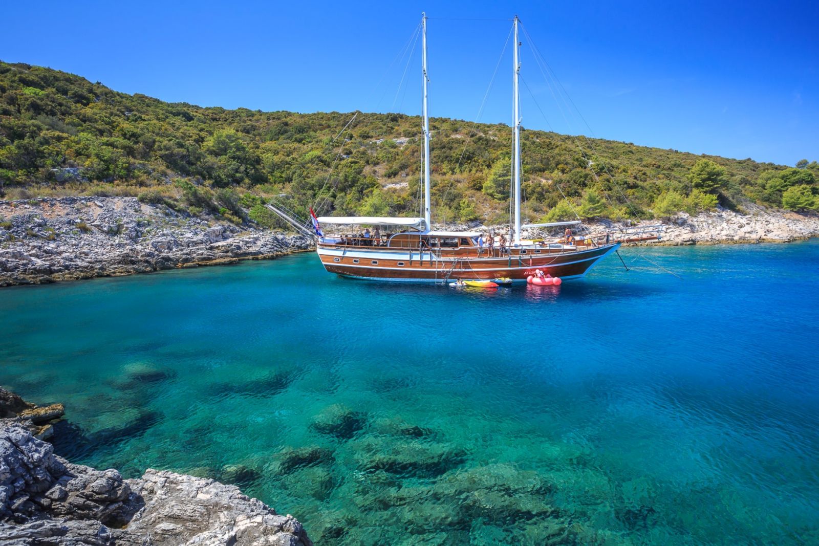 The Allure gulet moored in a calm bay of turquouse waters in Croatia