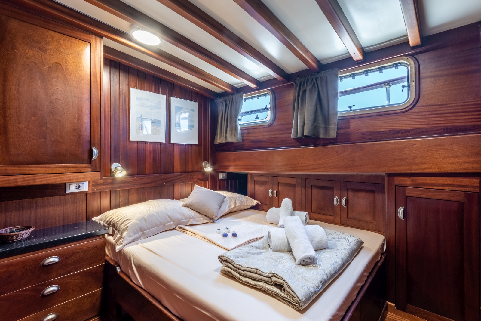 Double cabin with plenty of storage and windows onboard the luxury gulet Angelica