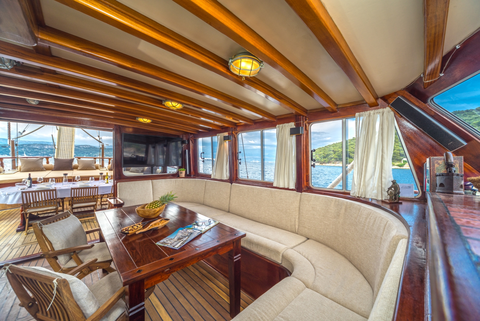 Indoor sitting area ith flatscreen tv and speakers onboard the luxury gulet Angelica