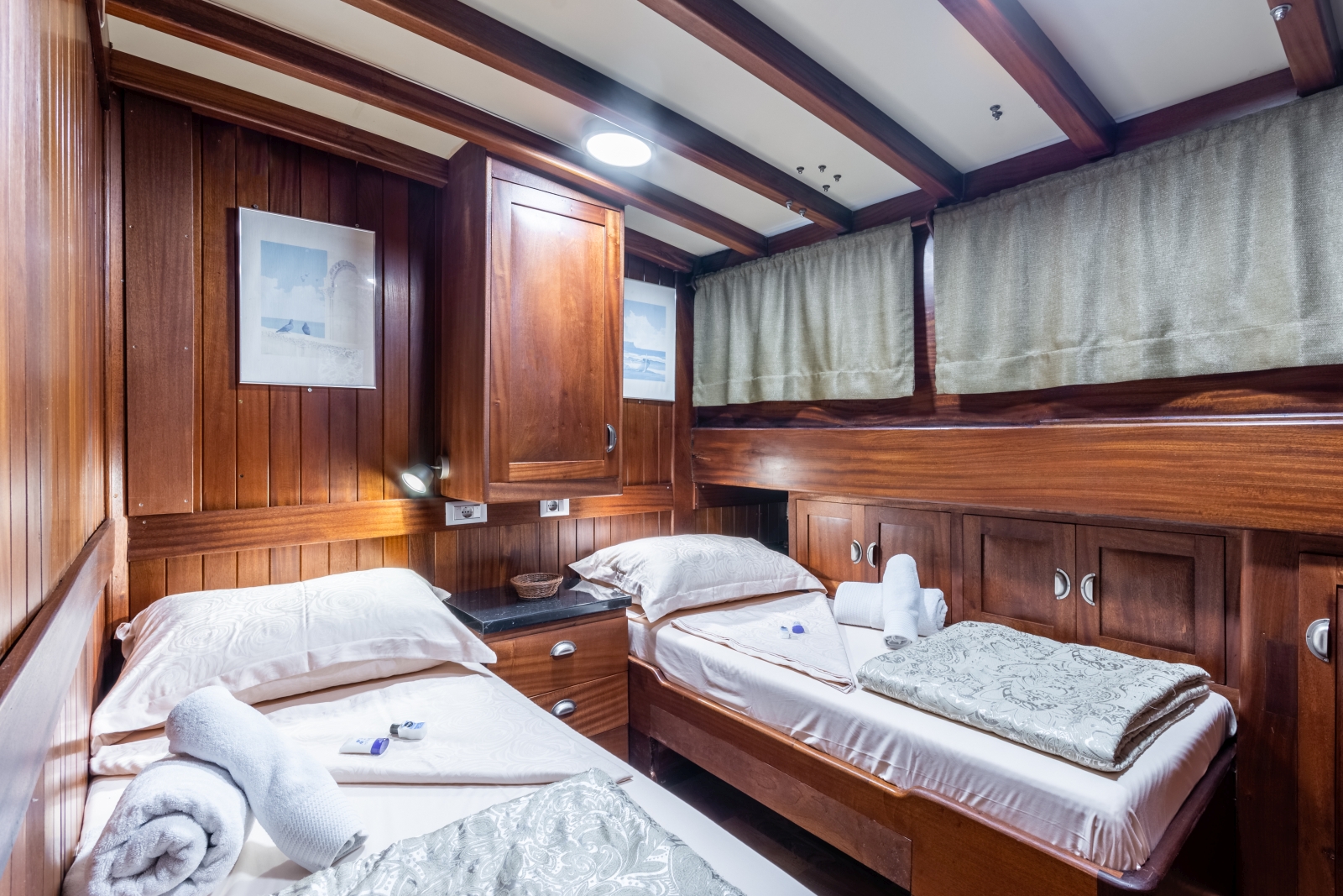 Twin cabin with storage and windows onboard the luxury gulet Angelica
