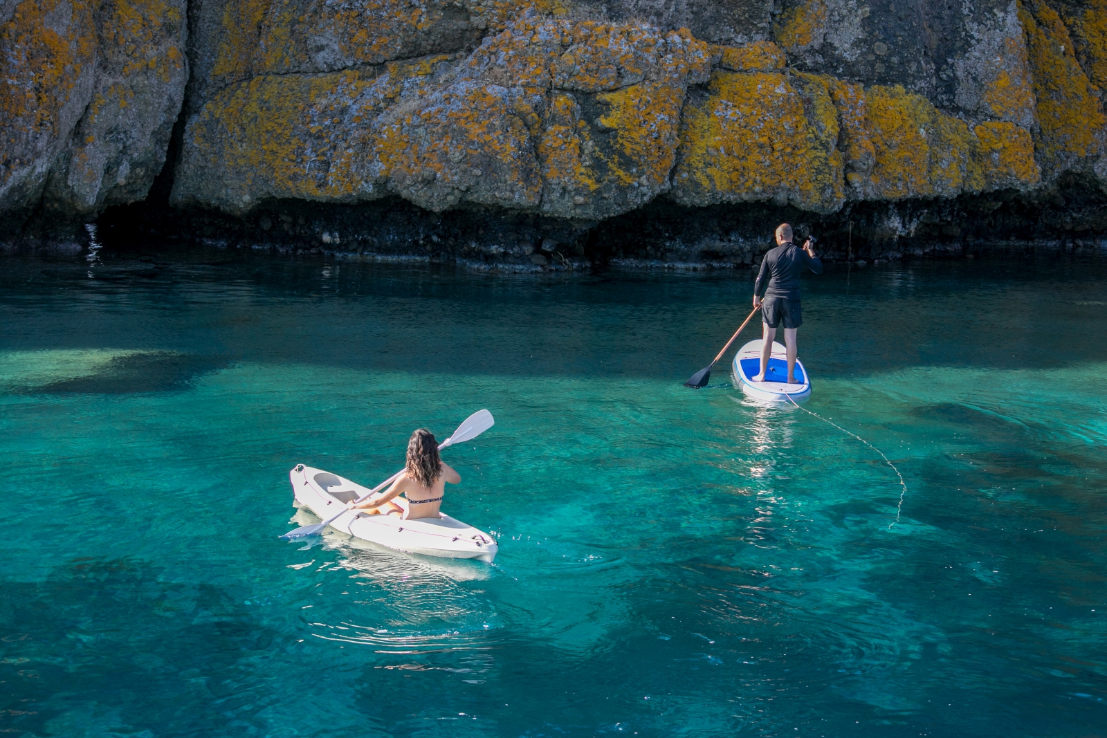 Guests on the water with a kayak and a SUP