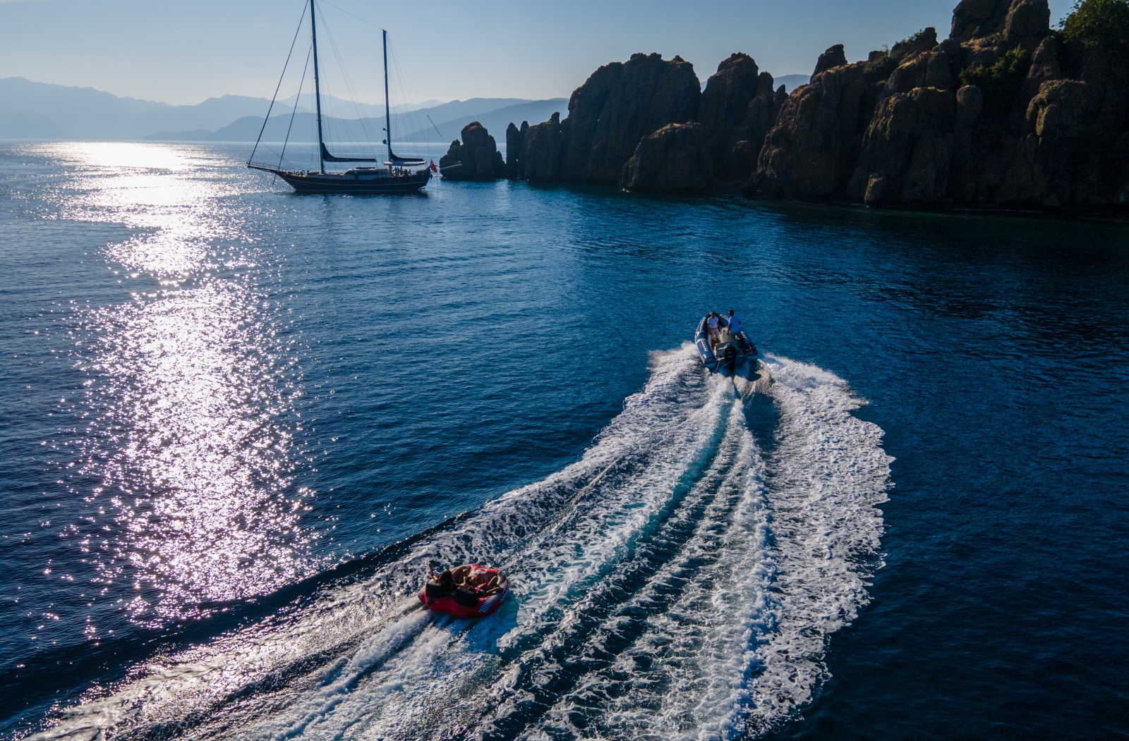 Guests enjoying a ringo ride with luxury gulet Blue Heaven anchored by the coast