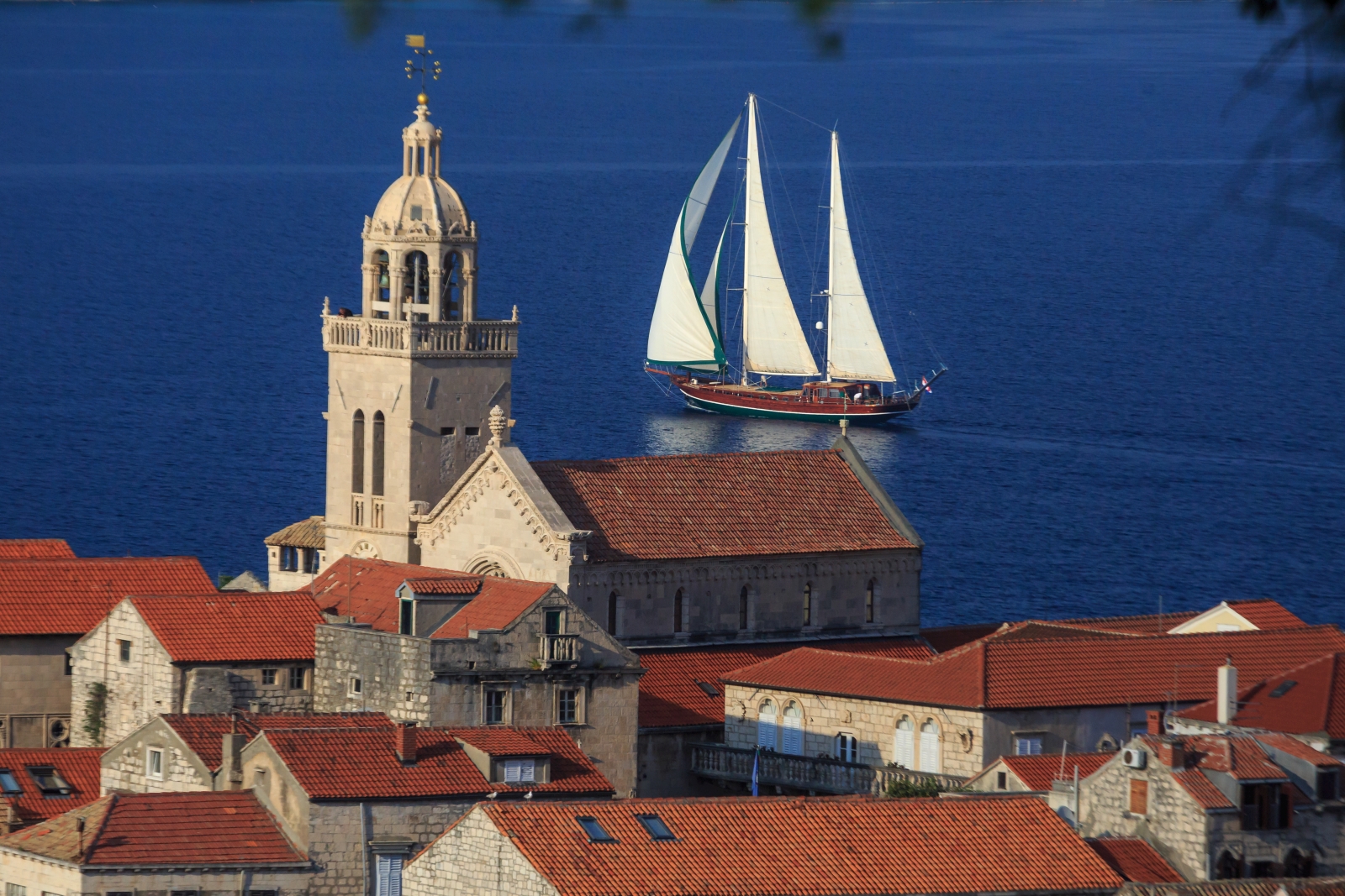 the luxury gulet Carpe Diem 7 sailing past a Croatian town