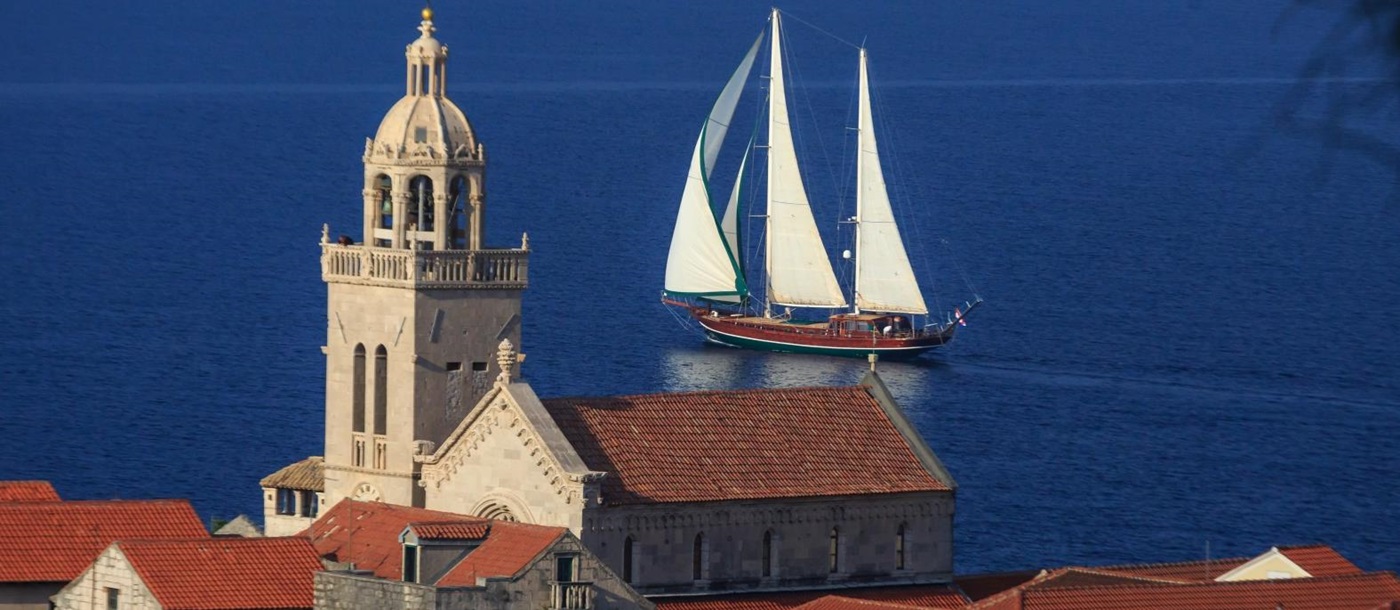 the luxury gulet Carpe Diem 7 sailing past a Croatian town