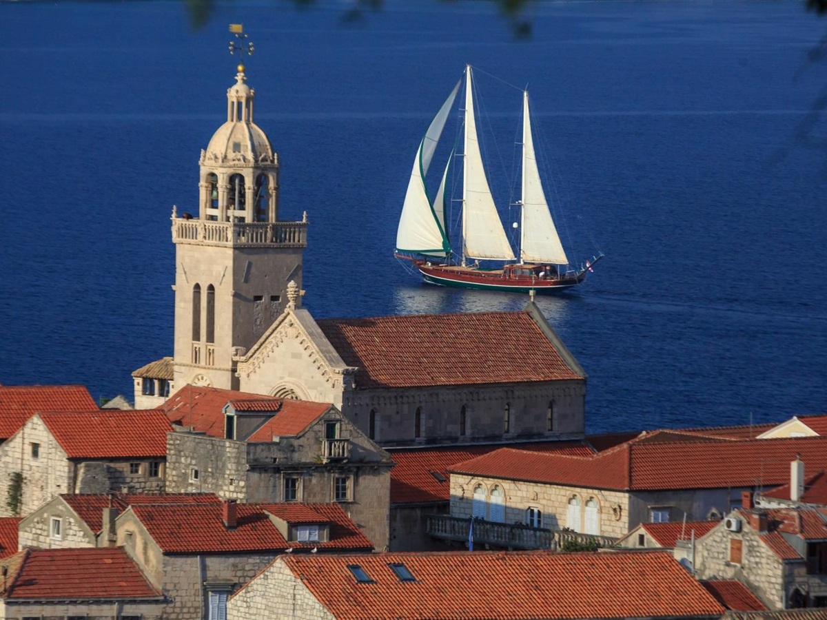 the luxury gulet Carpe Diem 7 sailing past a Croatian town