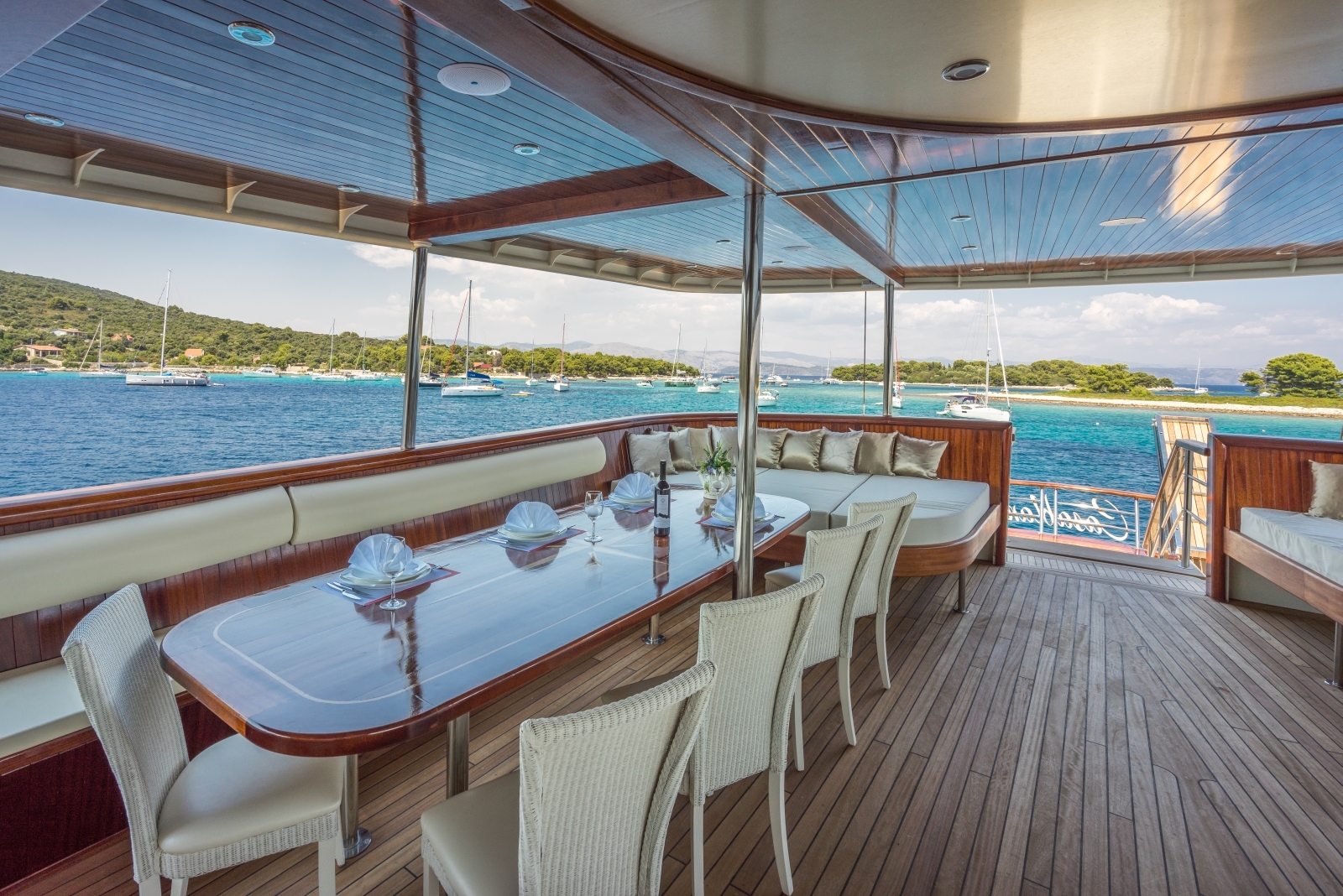 Shaded dining area with seating for ten people on the deck of luxury gulet Casablanca