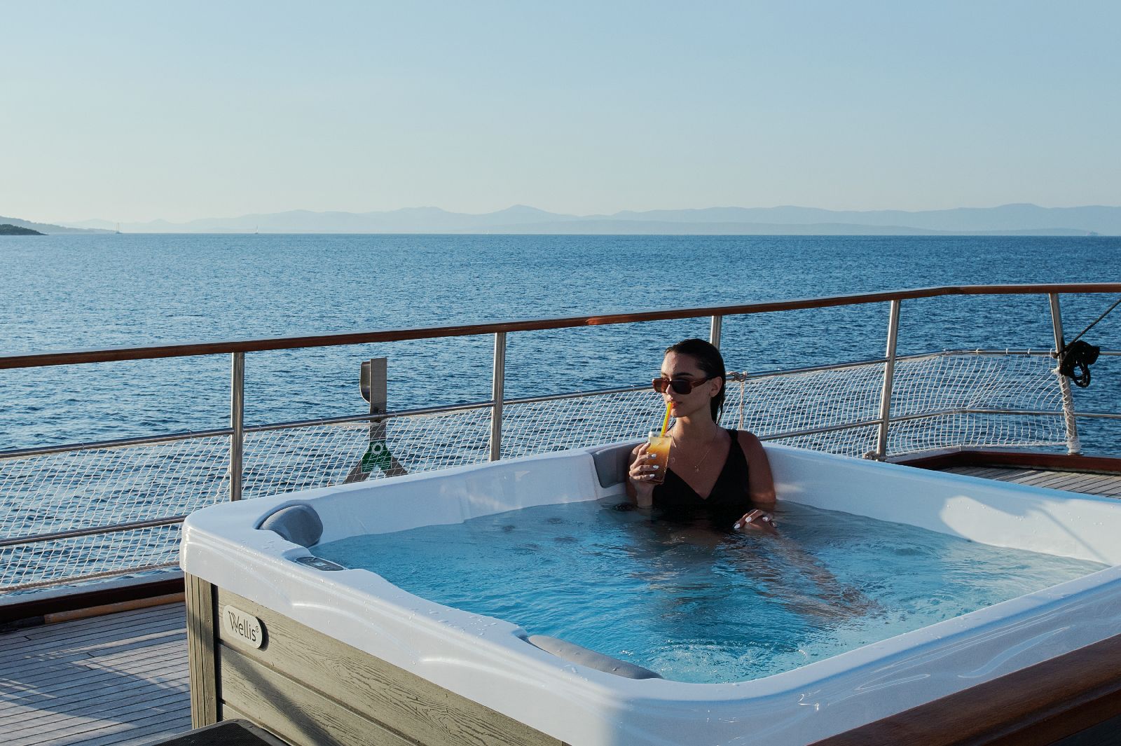 Guest enjoying the outdoor Jacuzzi on board the motor yacht Cataleya in Croatia