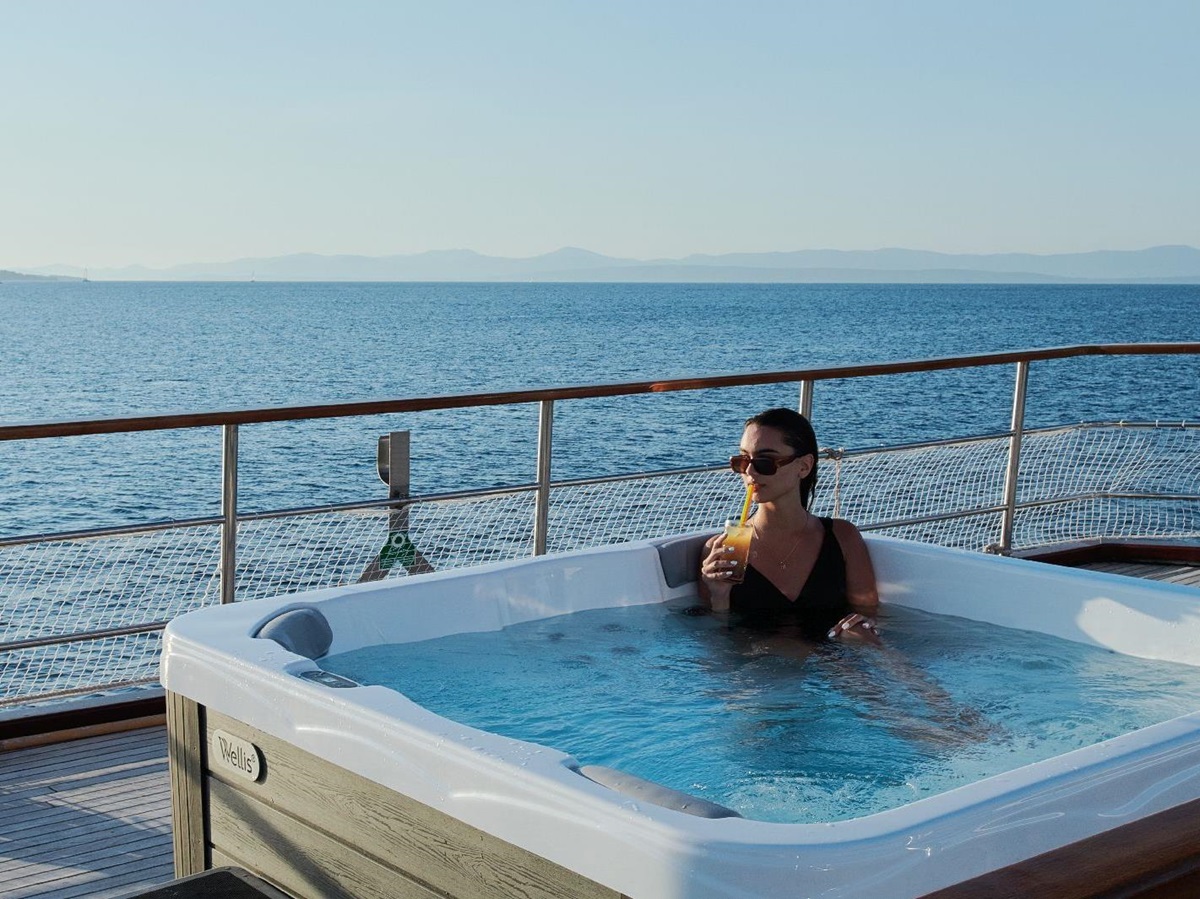 Guest enjoying the outdoor Jacuzzi on board the motor yacht Cataleya in Croatia