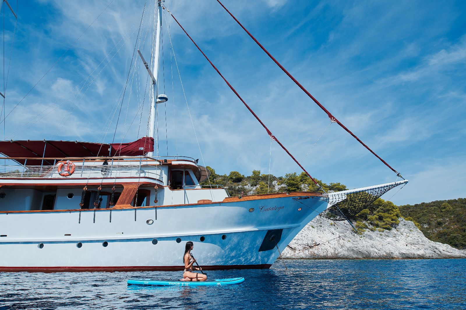 Guest paddle boarding from the motor yacht Cataleya in Croatia
