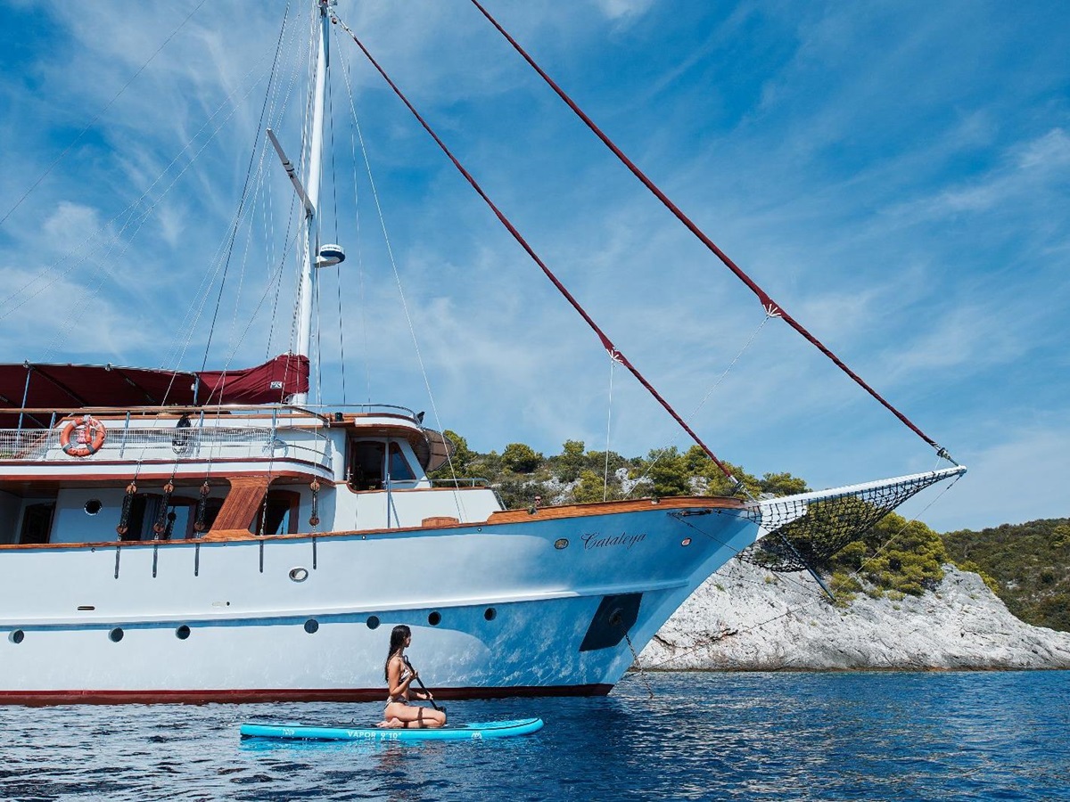 Guest paddle boarding from the motor yacht Cataleya in Croatia