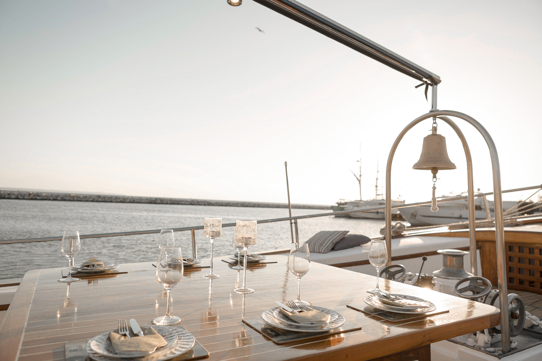 Alfresco dining table at sunset onboard the Cosmos luxury yacht in Greece
