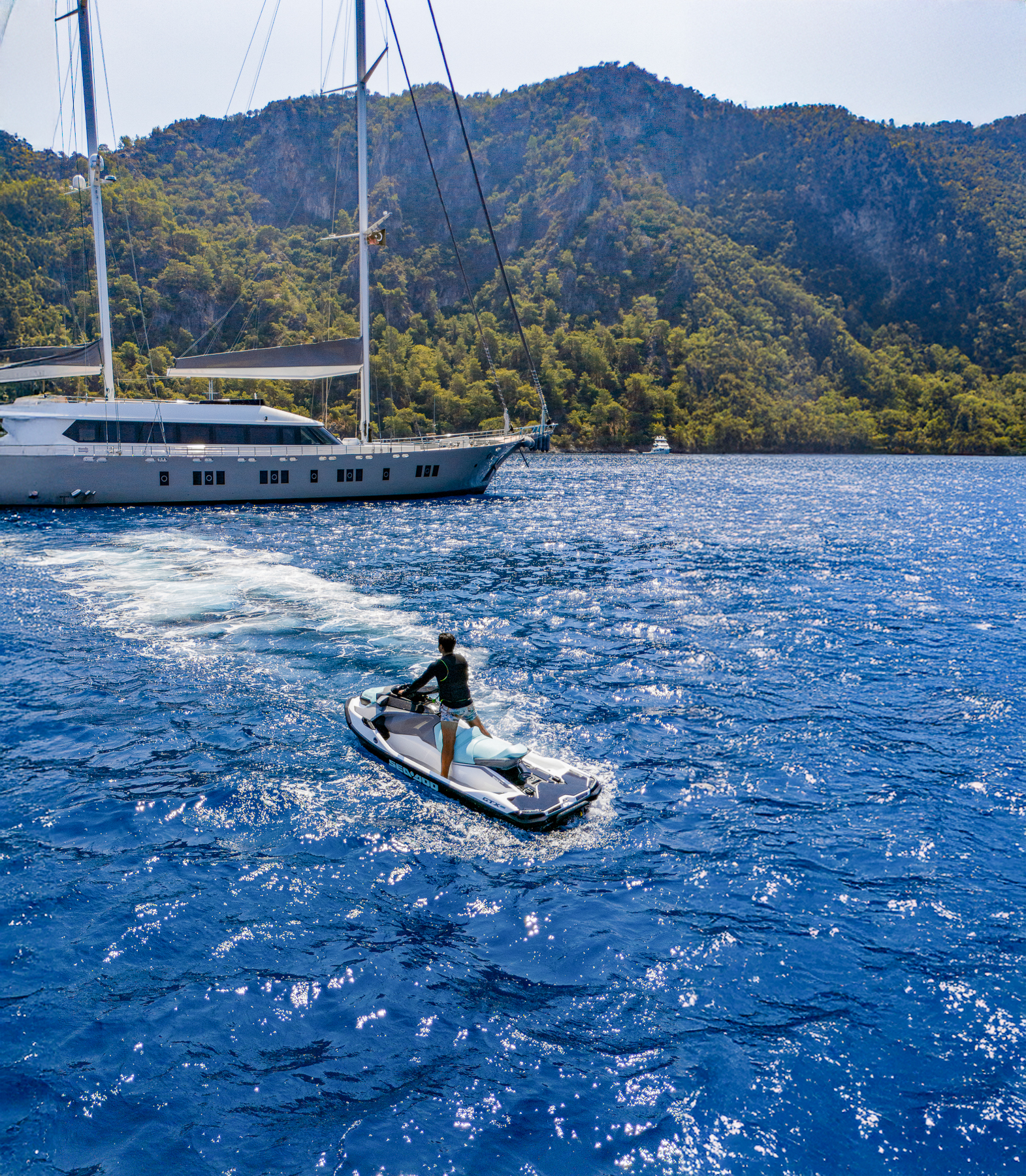 A man jetskiing from the De Love luxury motor sailer in Turkey